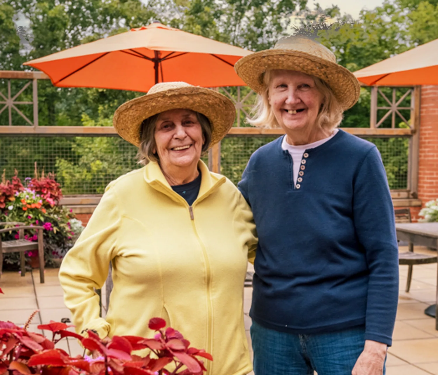 two women in hats on patio