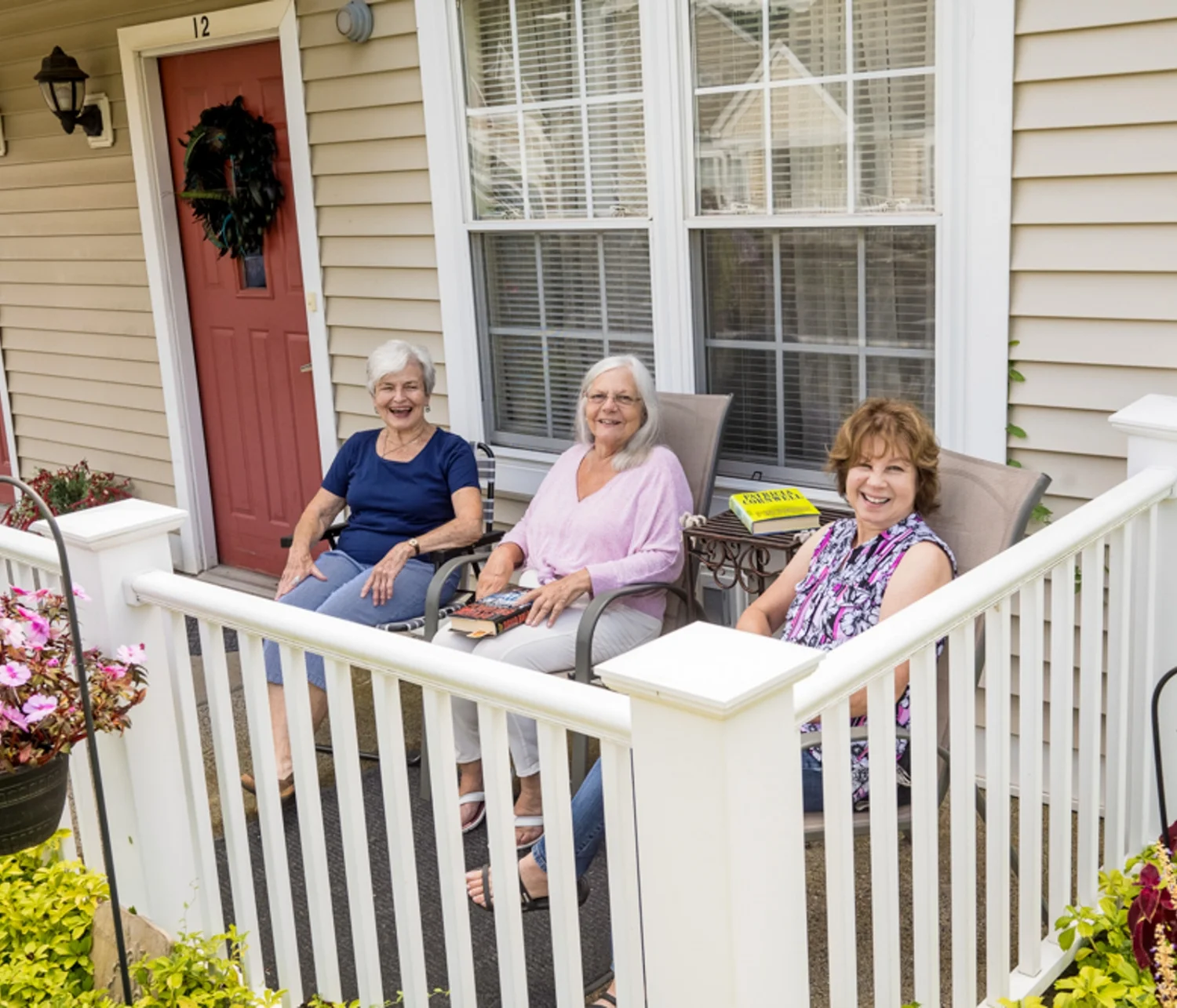 three women sitting on a Cedar Ridge front porch