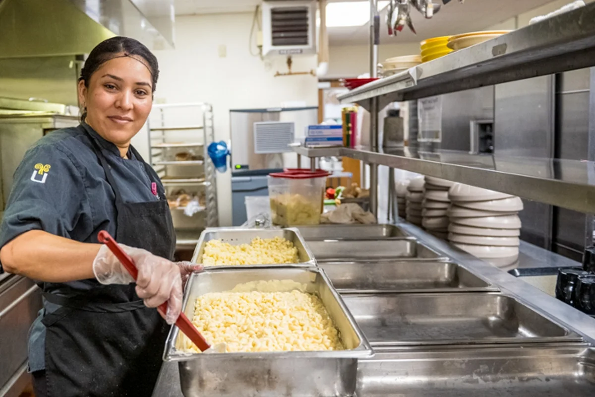 chef making food in facility kitchen