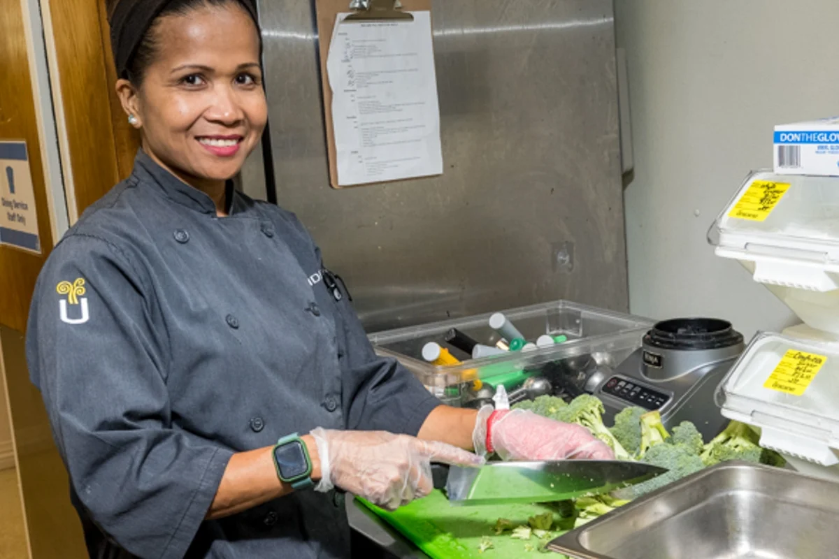 woman chopping broccoli